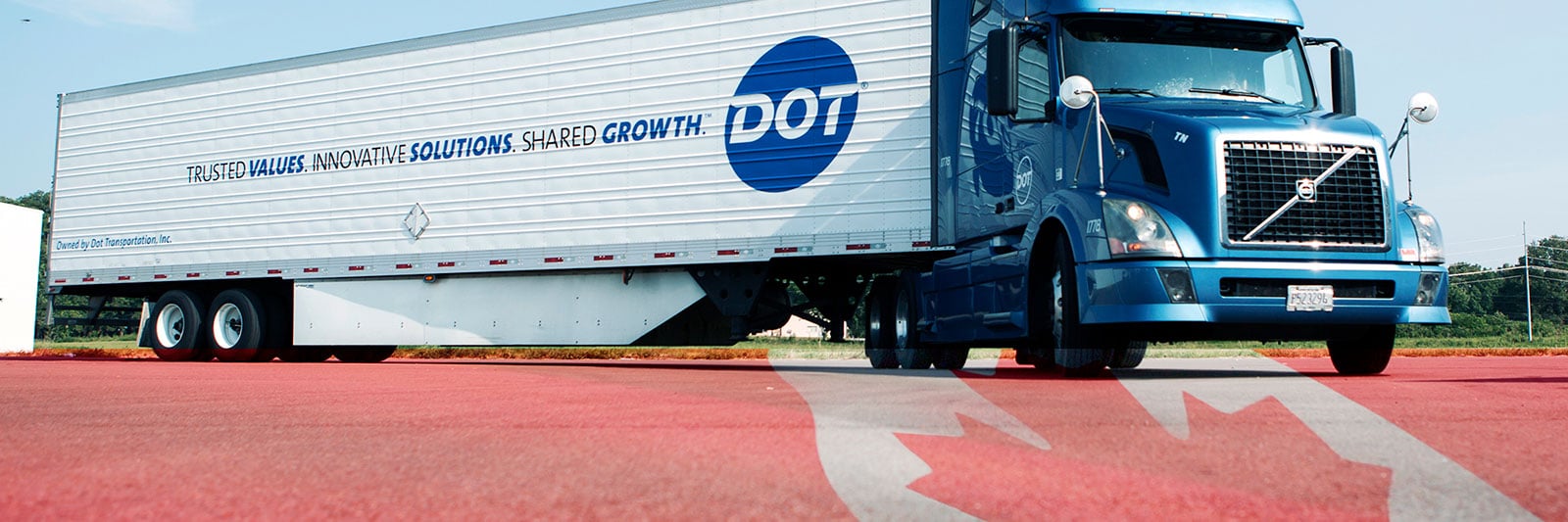 Dot Foods truck with Canadian flag embedded on the road
