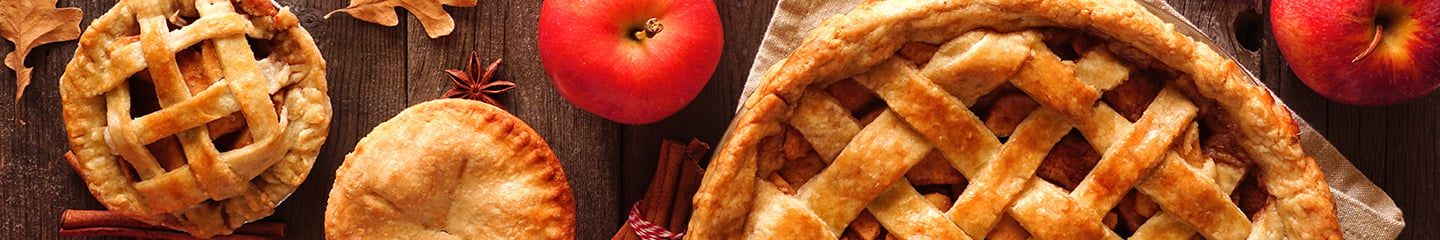 Close up of apple pies and two red apples