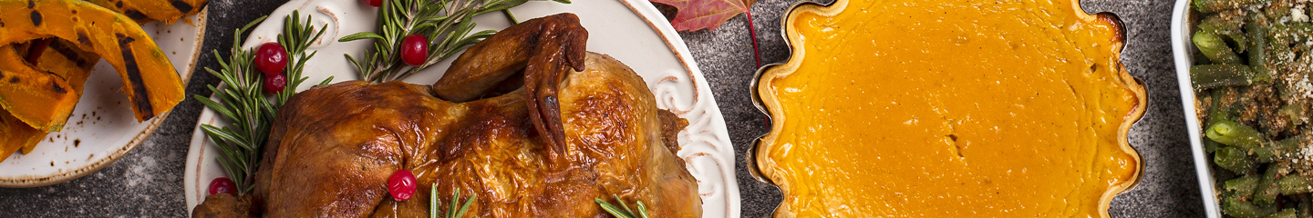 Thanksgiving dinner with squash, roasted turkey, pumpkin pie, and vegetables