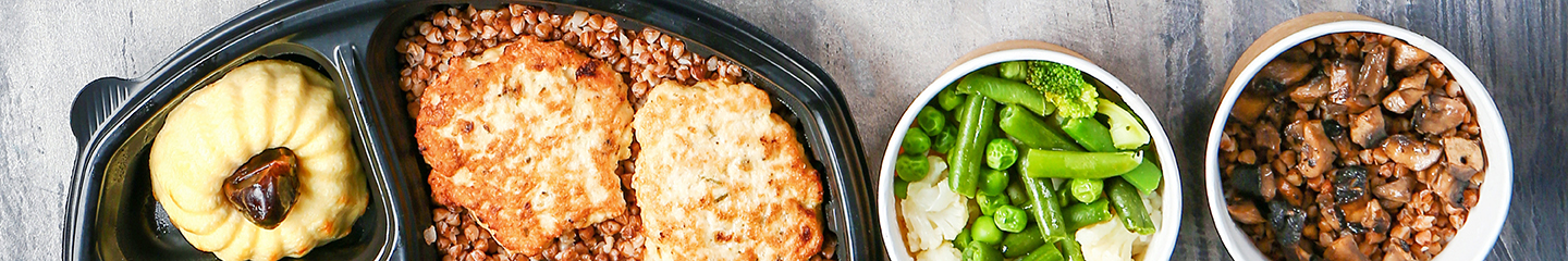 Meat, vegetables, and dessert packed up in disposable takeout containers