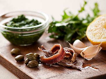 Globally sourced capers, anchovies, and pesto