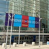 Front of glass building with LED screen showing Innovations 2024 logo 