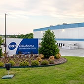 Outside view of warehouse with Dot Foods Oklahoma sign at sunrise