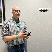 Man flying drone inside