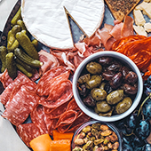 An overhead view of a charcuterie and cheese board