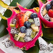 Two dragonfruit skins filled with fruit on a plate