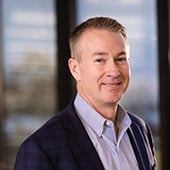 Dot Foods President Dick Tracy in front of windows at Dot Foods Mt. Sterling