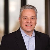 Vice President of Corporate Accounts Jeff Grever in front of windows at Dot Foods Mt. Sterling