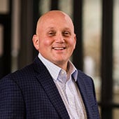 Vice President of Human Resources Matt Holt in front of windows at Dot Foods Mt. Sterling