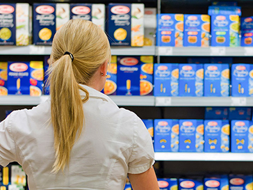 Rear view of women in grocery store looking at pasta