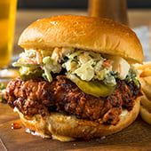 Pulled pork barbecue sandwich with pickles and slaw
